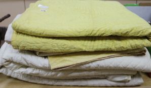 Four cream and yellow quilts