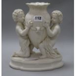 A centrepiece of putti holding a vase