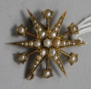 A late Victorian 15ct gold and seed pearl starburst pendant/brooch, 29mm.