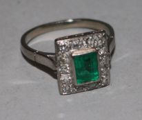 A white gold, emerald and diamond rectangular cluster ring, size I.