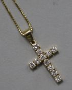 An 18ct gold and diamond cross pendant on an 18ct gold chain, pendant 23mm.