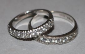 Two 18ct white gold half eternity rings, both set with colourless stones.