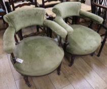 A pair of upholstered tub chairs