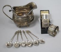 A George III silver cream jug, a Victorian silver napkin ring (cased), two other napkin rings and