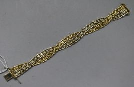 An Italian 18ct two colour gold interwoven bracelet, 8.5cm, 39.2 grams.