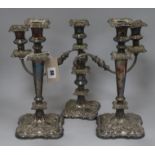 A pair of plated candlesticks and a plated candelabra