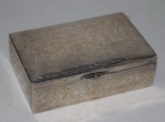 An Egyptian silver mounted rectangular cigarette box, with engraved decoration, 14.2cm.