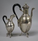 A 19th century Empire style silver coffee pot and cream jug, of ovoid classical form, each with