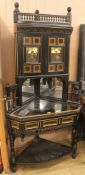 An ebonised Arts and Crafts corner cabinet, H.196cm