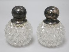 A pair of late Victorian silver topped cut glass scent bottles, by John Grinsell & Sons, London,