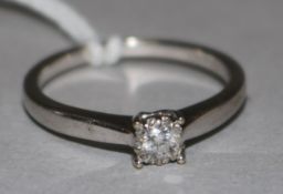 An 18ct white gold and single stone diamond ring surrounded by rose cut diamonds, size O.