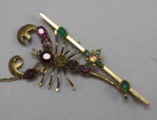 A gold, emerald and white opal set bar brooch and a gold and gem set scorpion brooch.