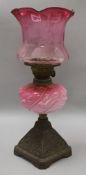 A cranberry shaded oil lamp