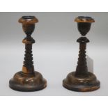 A pair of lignum vitae candlesticks