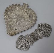A pair od Indian white metal buckles and a filligree work stand.
