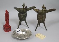 A pair of bronze jue, a Chinese white metal dish, an ivory buckle and a figure