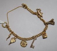 A 9ct gold charm bracelet, hung with seven charms, gross 19.7 grams.