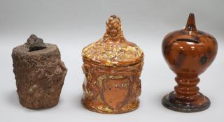 An earthenware money box, a tobacco jar with lid and a Sussex pottery money box