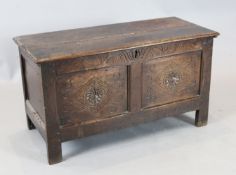 A late 17th century oak coffer, the front with two panels carved with lozenges and fleur de lys, W.