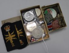 A quantity of military badges, coins and medals
