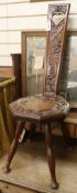 An Arts & Crafts carved oak milking stool, H.95cm