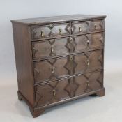 An early 18th century oak chest, of two short and three graduated long drawers with geometric