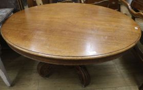 An oak oval extending centre table, with three leaves W.150cm