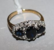 An 18ct gold, sapphire and diamond cluster ring, size M.