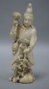 A Japanese carved ivory okimono of a huntsman, Meiji period, holding a hawk and a brace of birds