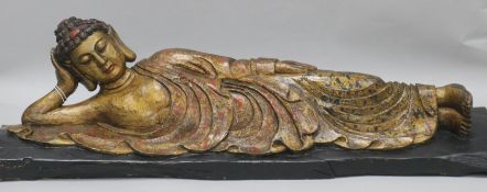 A Burmese polychrome and giltwood reclining figure of Buddha