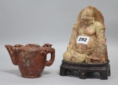 A soapstone buddha and a pot