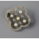 An Edwardian white gold diamond and pearl trellis pattern brooch, 26mm.
