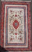 A Persian Tabriz style rug, with central medallion in a field of scrolling foliage, on a blue and