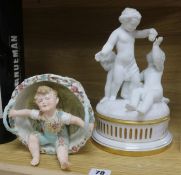 A Parianware putti table centre and a boy sitting in a basket ornament