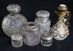 Five silver topped bottles and a perfume bottle.