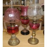 Three oil lamps with ruby glass reservoirs