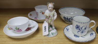 A Derby putto, a Worcester cup and saucer, a Berlin cup and saucer and three other items