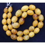A single strand amber bead necklace, with hook clasp, gross 63 grams, 56cm.