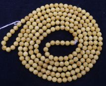 A single strand spherical amber bead necklace, gross 61 grams, 168cm.