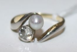 A 14ct gold, cultured pearl and diamond crossover ring, (shank a.f.), size M.