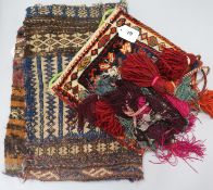 An Afghan saddle bag, a Turkish bag with woven and tasselled wool fringing and a Turkoman part