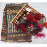 An Afghan saddle bag, a Turkish bag with woven and tasselled wool fringing and a Turkoman part