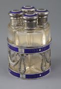 An early 20th century Austro-Hungarian silver and enamel mounted scent bottle stand fitted with four