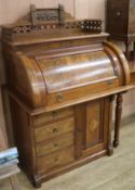 A late Victorian mahogany and walnut roll top desk, W.85cm