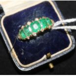 A gold and five stone emerald and diamond ring (stones badly worn, size O.