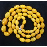 A single strand graduated oval amber bead necklace, gross 36 grams, 70cm.
