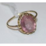 A gold and single stone pink topaz ring, (worn), size J.