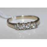 A modern 18ct gold and four stone diamond ring, size J.