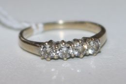 A modern 18ct gold and four stone diamond ring, size J.