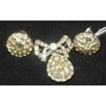 A 1930's paste set silver demi parure, comprising a brooch and pair of ear clips.